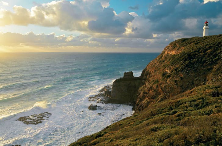The Cape Schanck Lighthouse on Victoria's Mornington Peninsula. The sun is setting over Bass Strait.