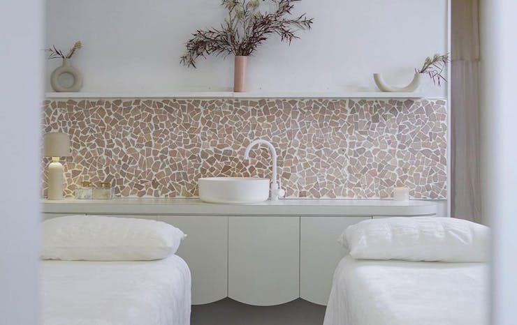 two massage beds in a Perth day spa room with pink-hued tiles