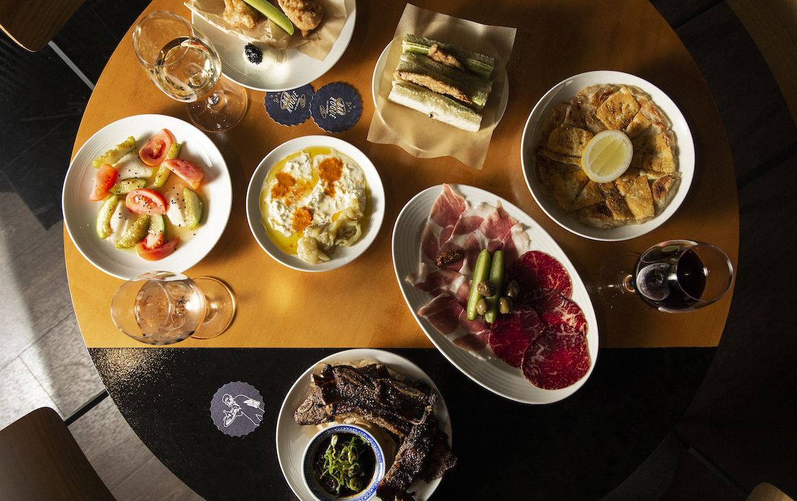 a table filled with dishes and glasses of wine at Bar Rogue