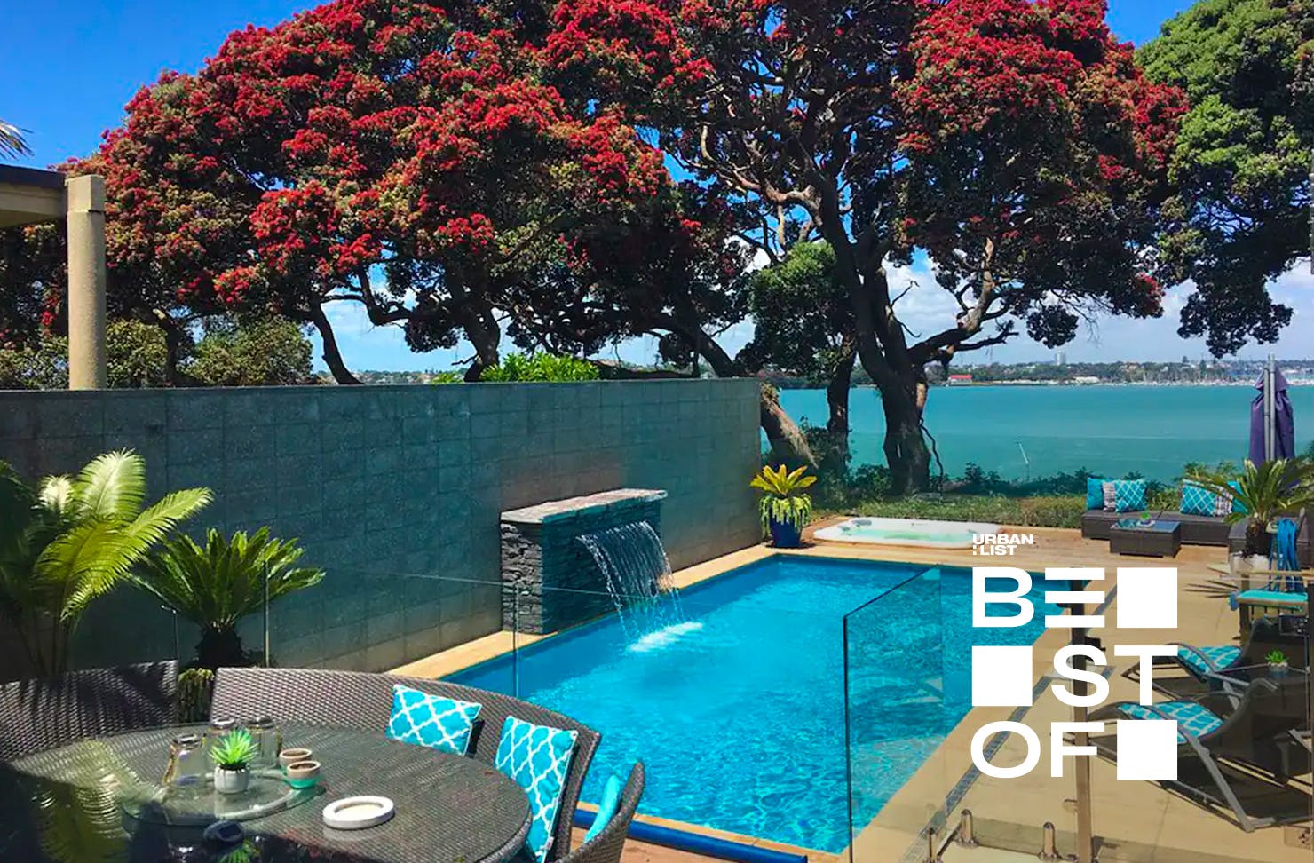 Dining table with pool (complete with fountain), spa pool and view of the sea. 