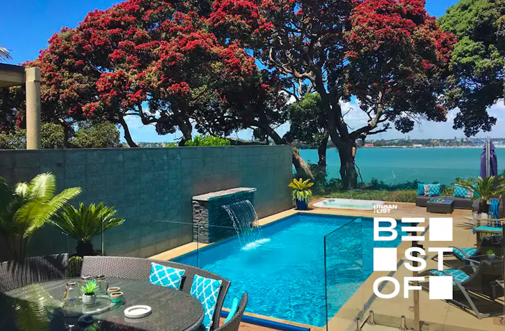 Dining table with pool (complete with fountain), spa pool and view of the sea. 