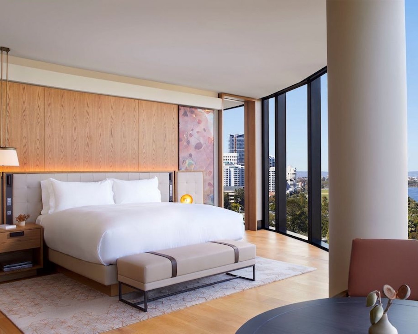 a light and bright hotel room with floor to ceiling windows