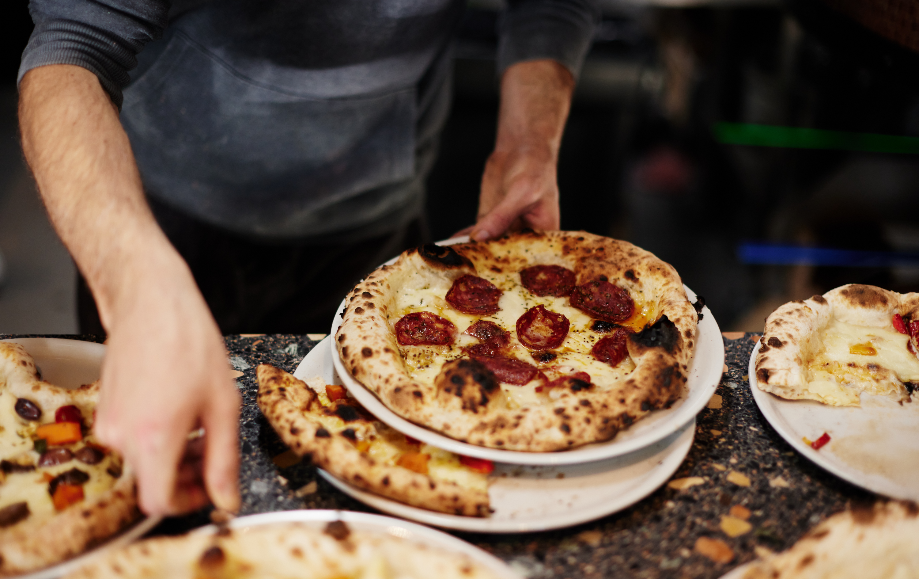 A woodfired Pizza coming out of the oven at one of Melbourne's best pizza restaurants, 400 Gradi.