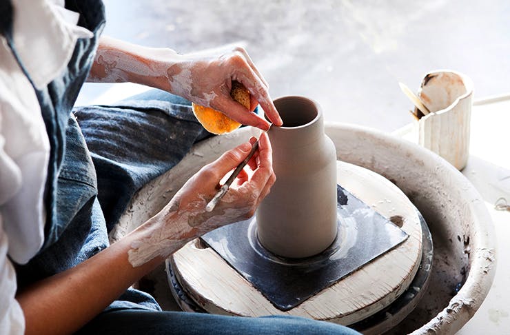 person working on a pottery wheel