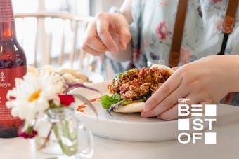 Someone digs into a feed at Table Of Munchies, one of the best restaurants in Christchurch.