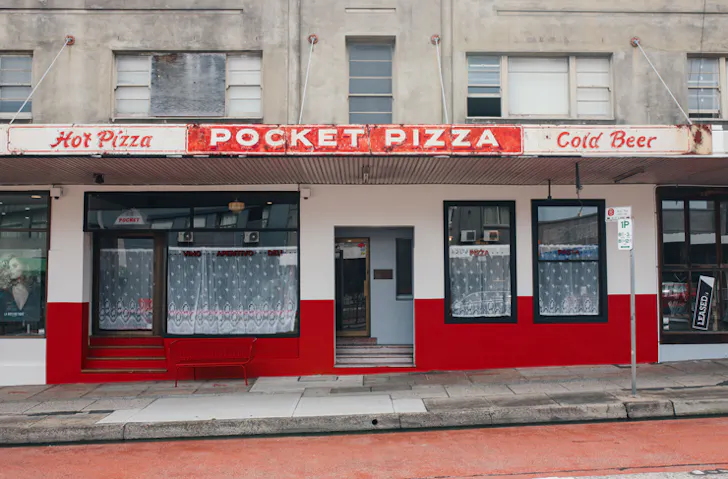 The red and white retro facade of Pocket Pizza in Brookvale
