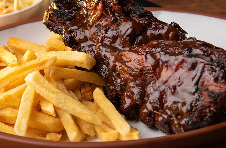 a close up of ribs and chips