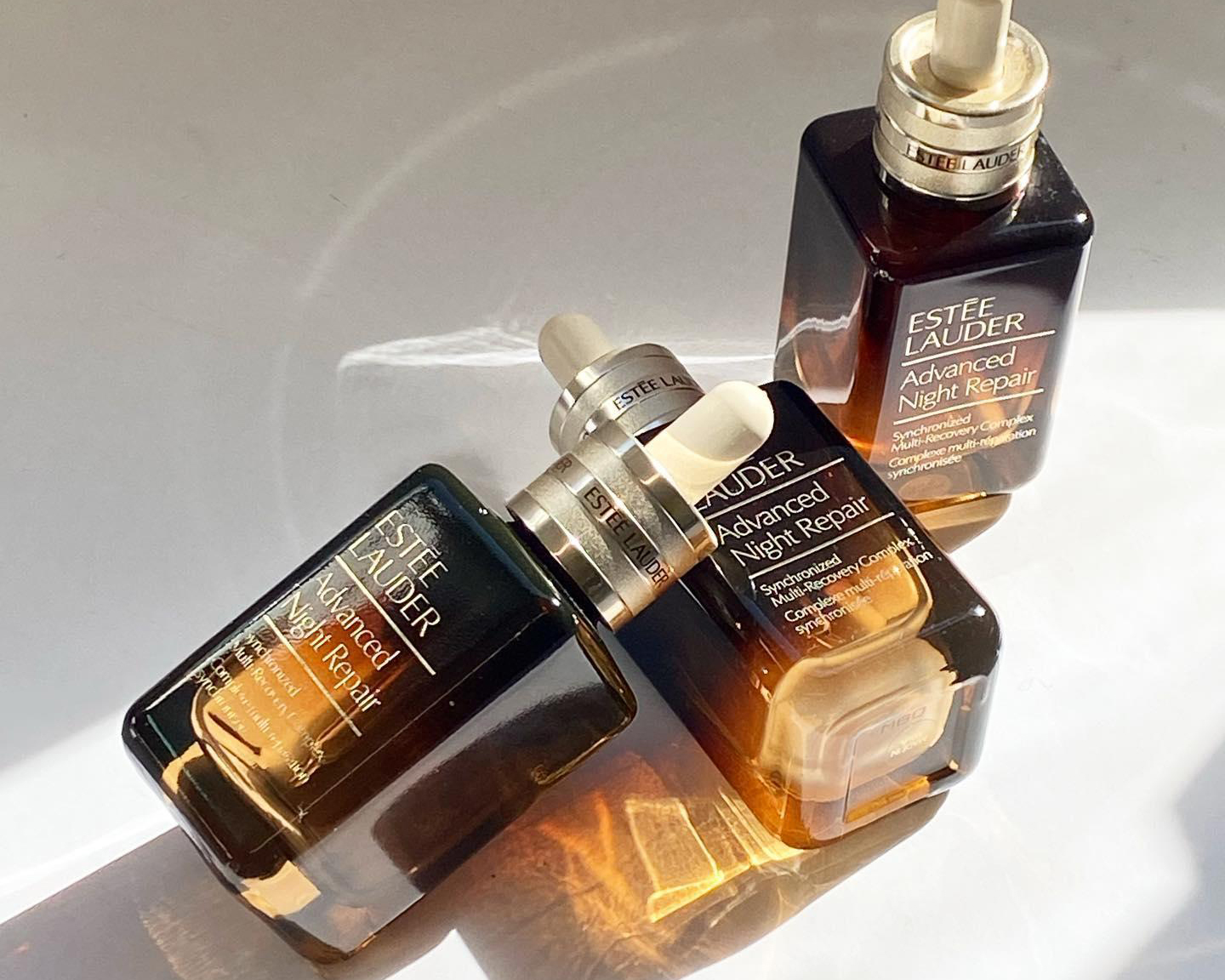 Estée Lauder advanced night repair bottles are stacked together.