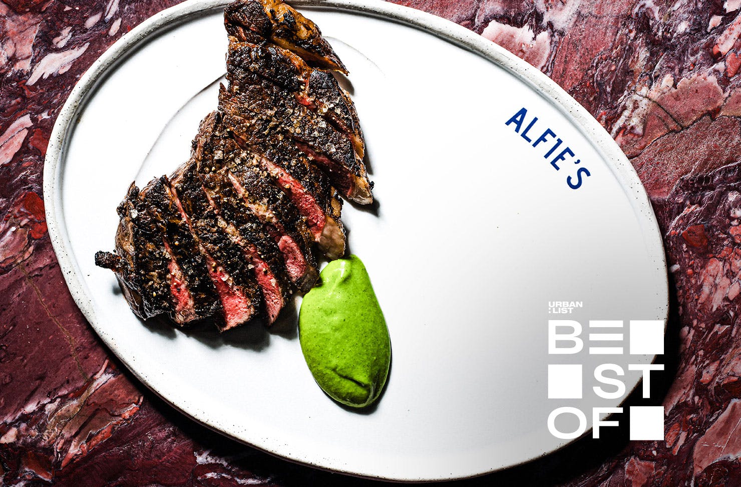 A sirloin steak on a white plate at Alfie's, one of the best restaurants in Sydney