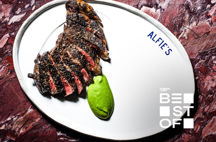 A sirloin steak on a white plate at Alfie's, one of the best restaurants in Sydney