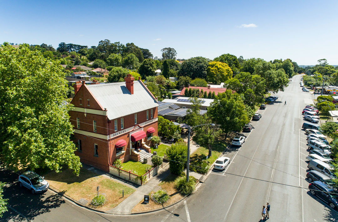 An aerial shot of Loch Distillery & Brewery along with the main street of Loch village in Victoria.