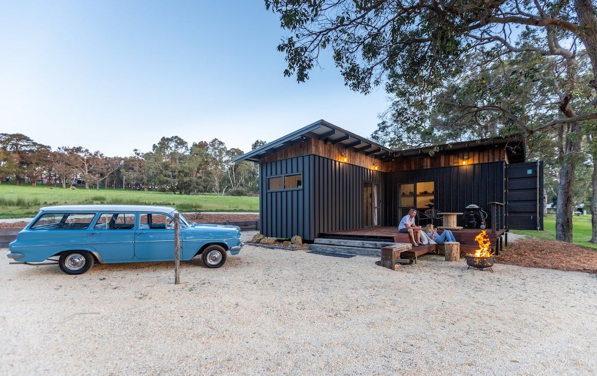 a tiny home with outdoor deck and fire