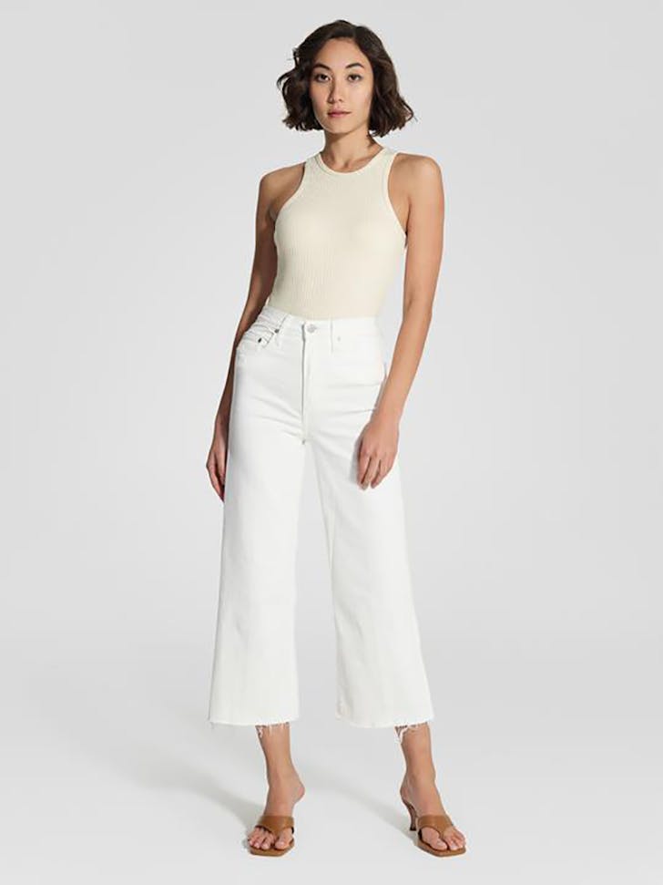 Some of the best wide leg jeans available for 2021, coloured white and sitting loosely on a model..