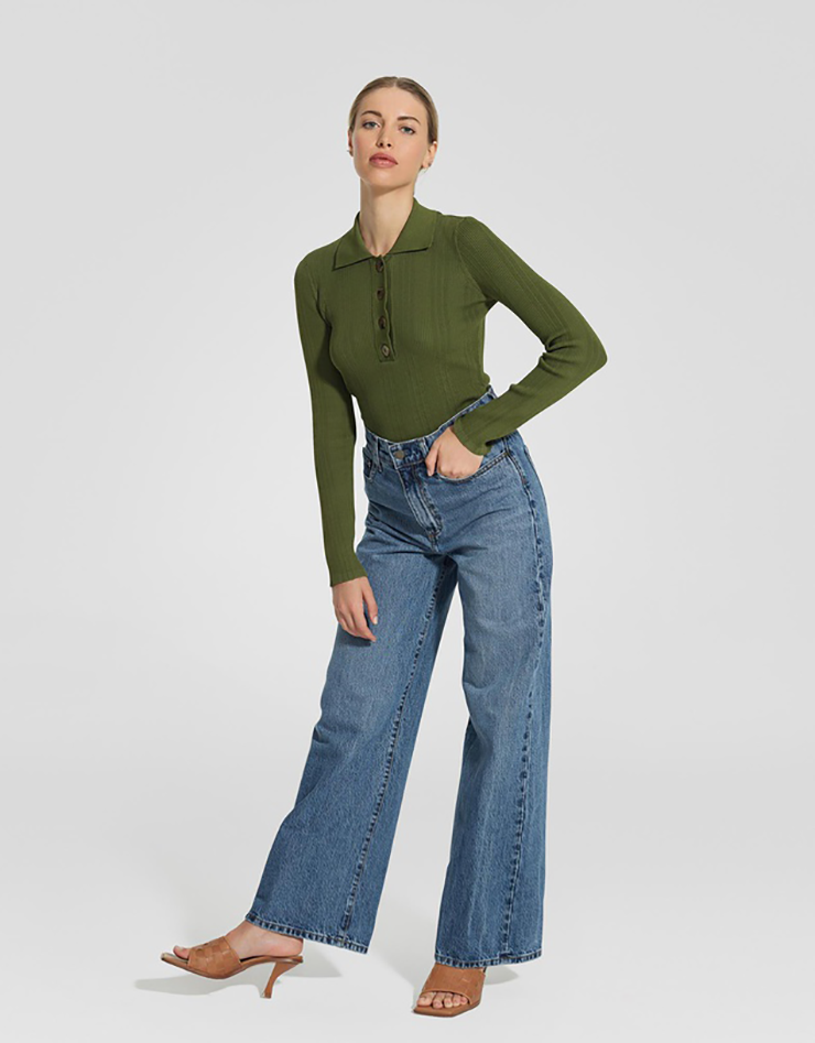 Some of the best wide leg jeans available for 2021, coloured medium blue and sitting loosely on a model..