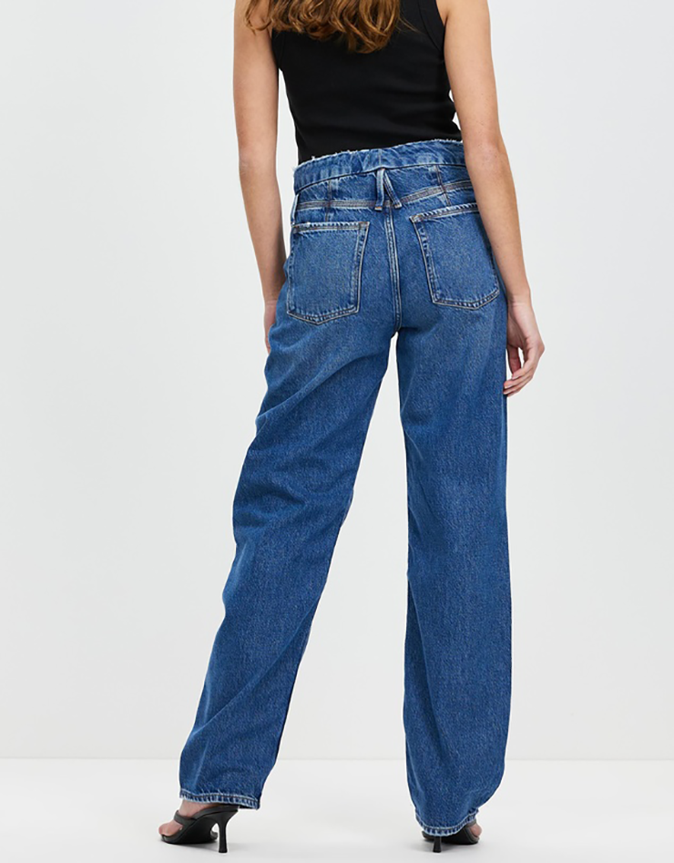 Some of the best wide leg jeans available for 2021, coloured indigo blue and sitting loosely on a model..