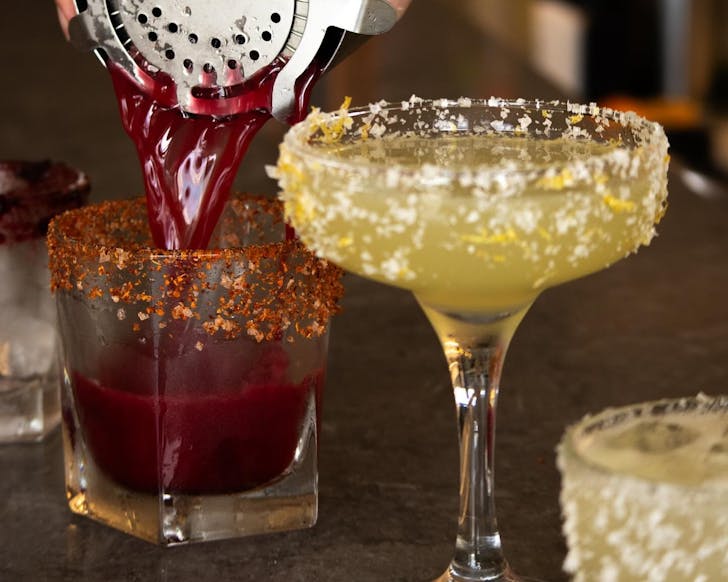 a deep red margarita is poured at the bar at maiz's bottomless brunch
