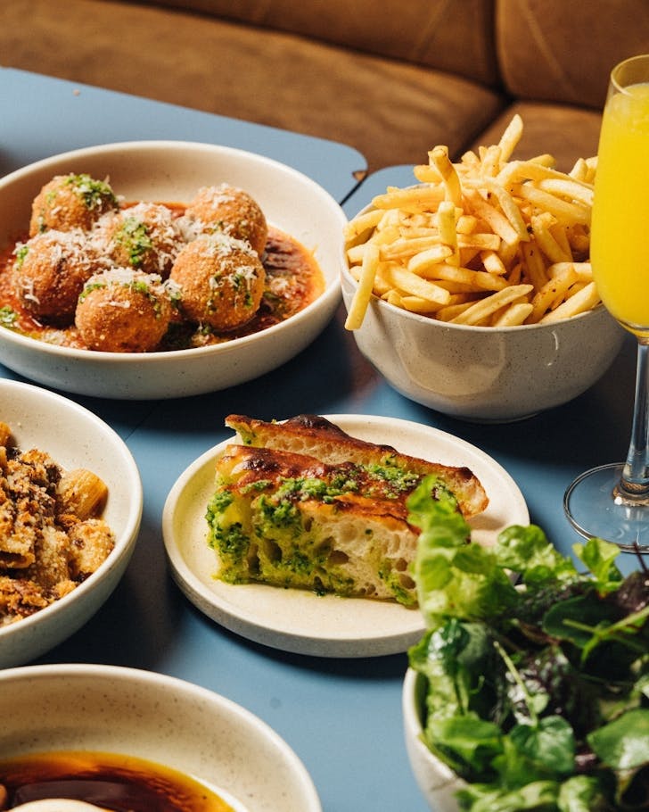 a spread of focaccia, arancini and fries at bottomless brunch at rocker bondi