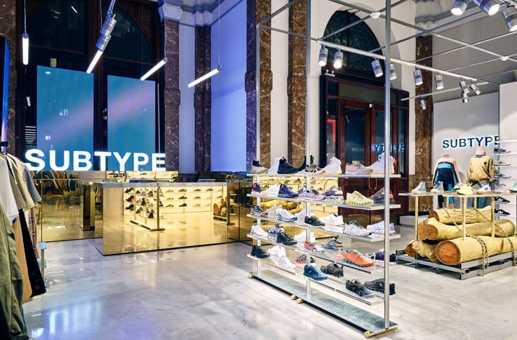 The gold counter and wall of sneakers at Subtype in Sydney. 
