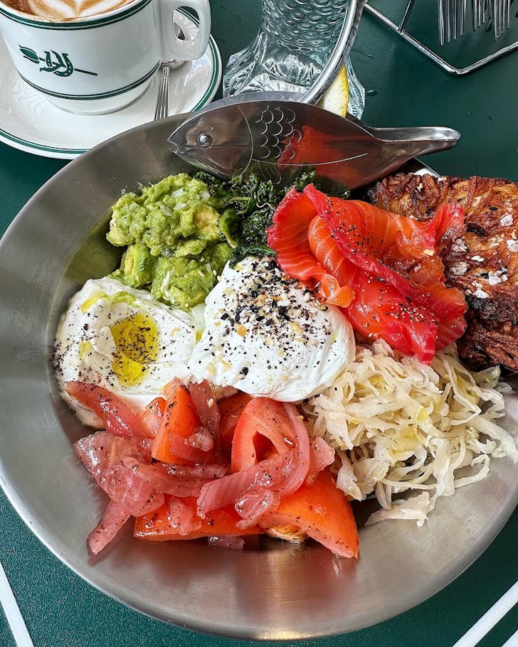a brunch plate of cured fish, eggs, dips and more at lox in a box cafe in bondi