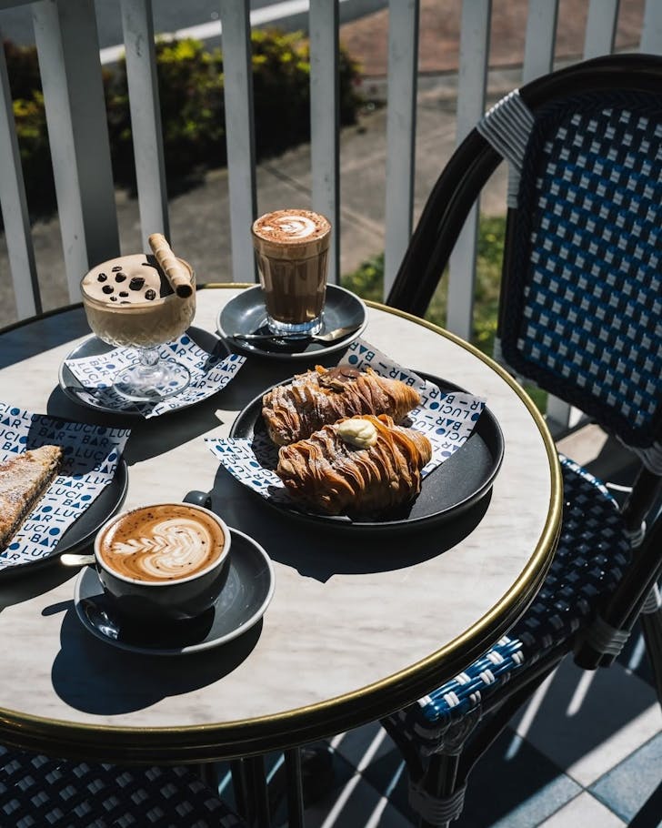 a table of coffees and italian pastries at sydney cafe bar lucio