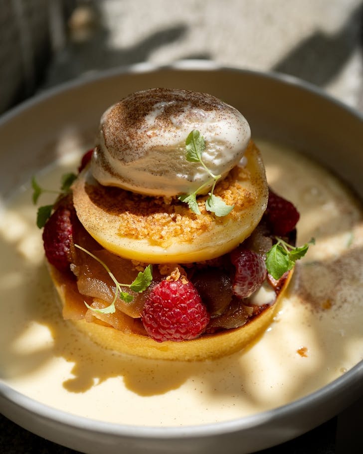 a stack of hotcakes topped with a portuguese tart at sydney cafe lunas