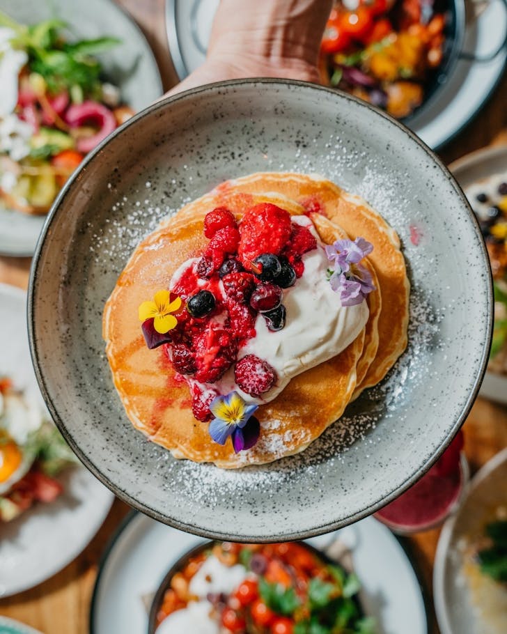 pancakes topped with berries at the grounds cafe in alexandria