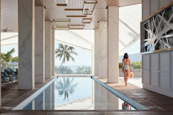 a woman walking along a pool