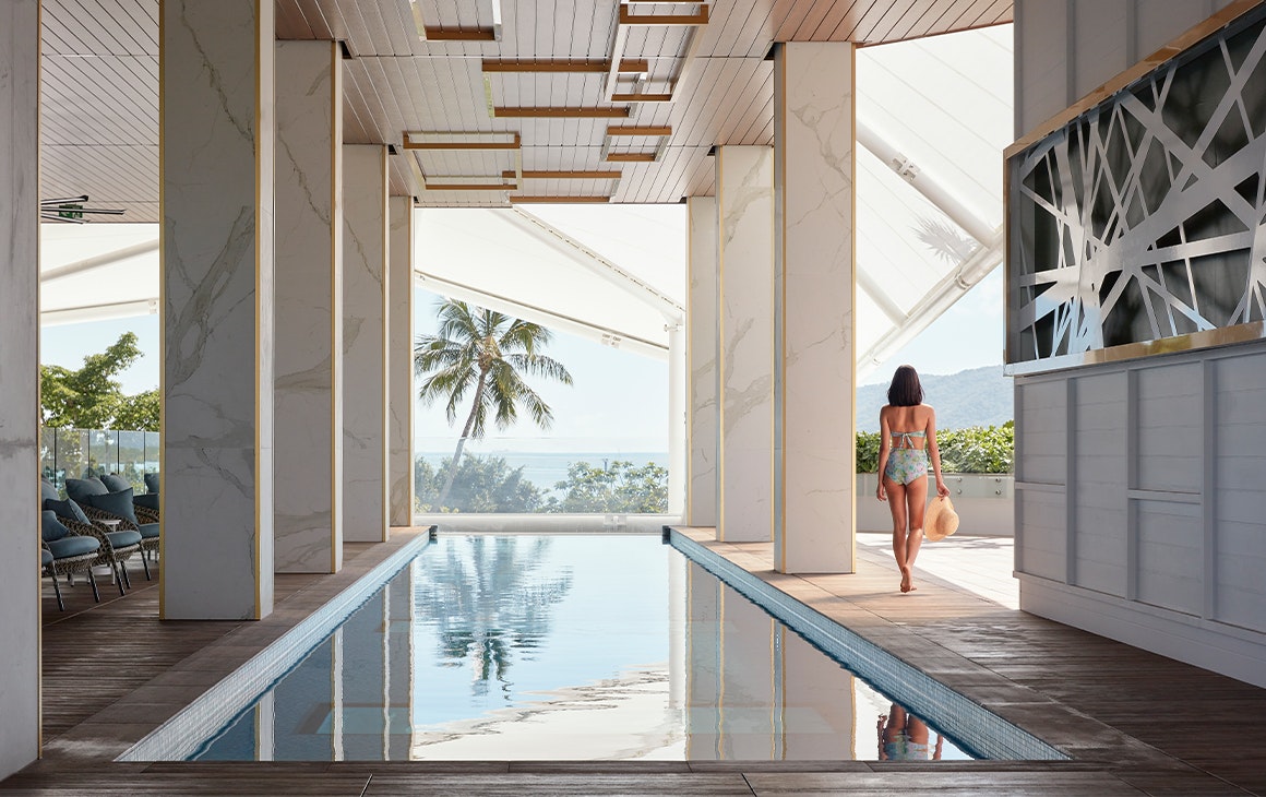 a woman walking along a pool