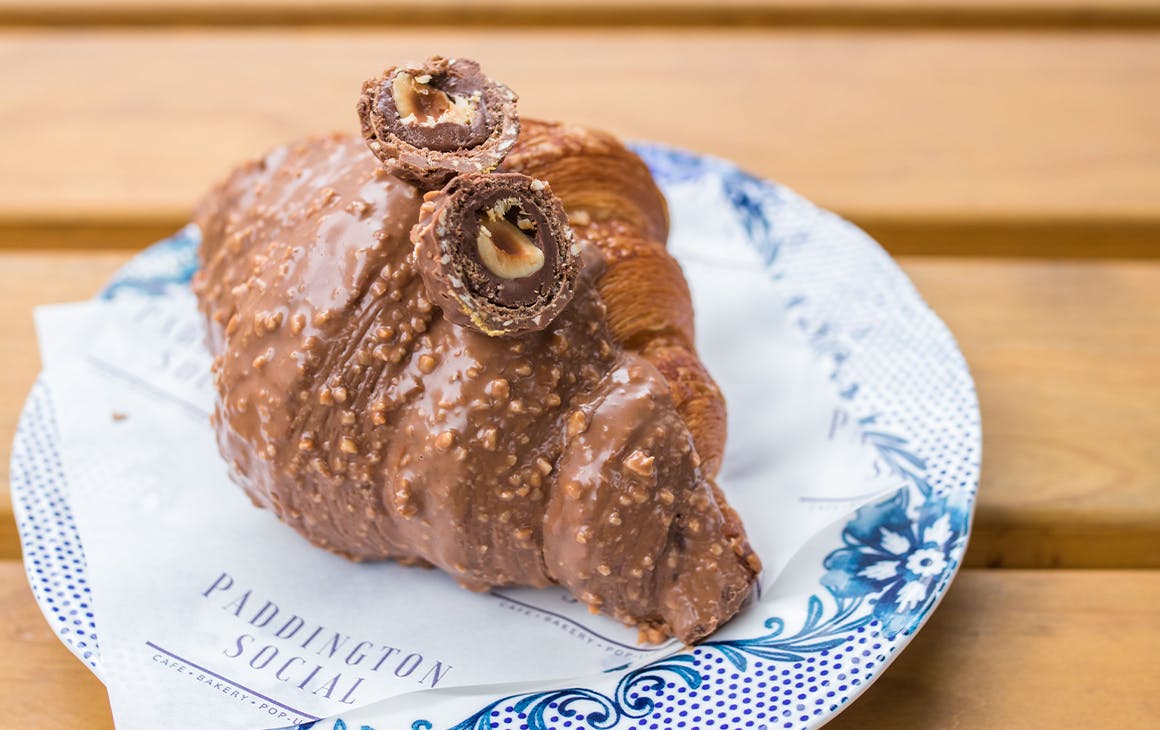 a chocolate dipped croissant topped with ferrero rocher