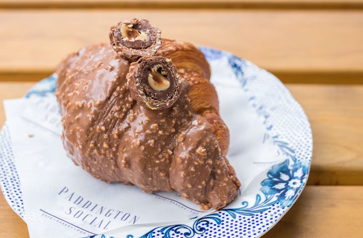 a chocolate dipped croissant topped with ferrero rocher