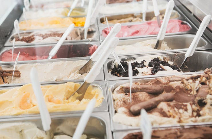 A display case filled with vats of colourful gelato.