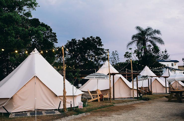 four canvas tents in a row