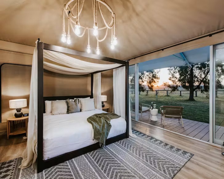 A four poster bed in the luxurious glamping tents at Parklands Resort in Mudgee