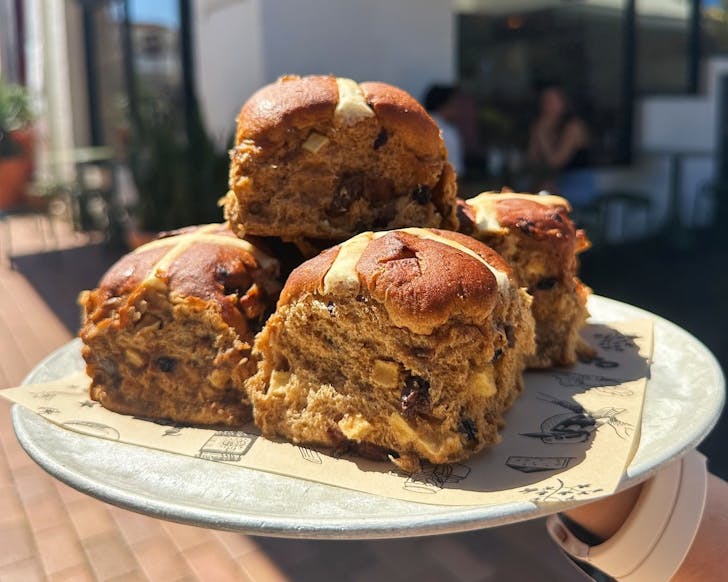a pile of fluffy hot cross buns in the sunshine