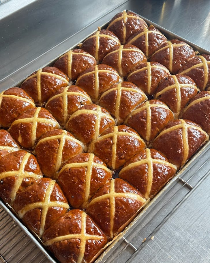 a bakery tray of fresh hot cross buns