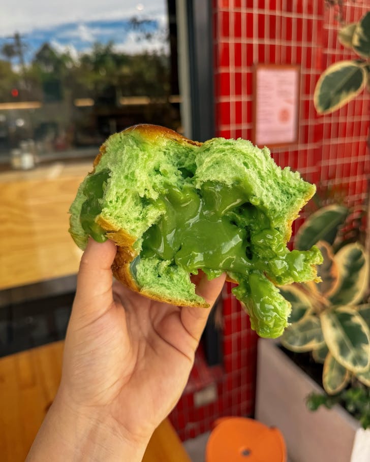 a vibrant green pandan hot cross bun from sydney bakery miss sina