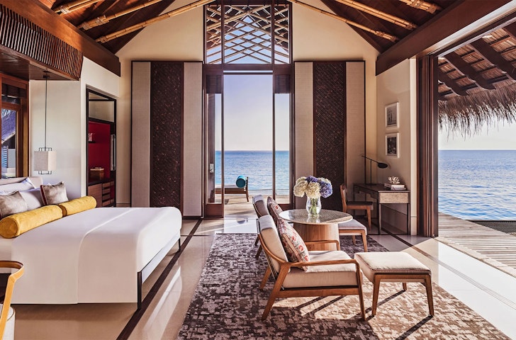 A view of a bedroom looking out to sea at ​One&Only; Reethi Rah  one of the Best Hotels In The Maldives