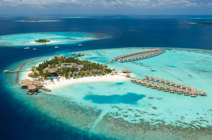 An aerial view of OUTRIGGER Maldives Maafushivaru Resort  one of the Best Hotels In The Maldives