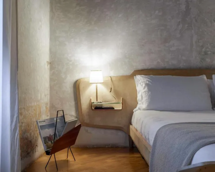 Best hotels in Rome at G-Rough with eclectic bedroom, exposed walls and vintage design details