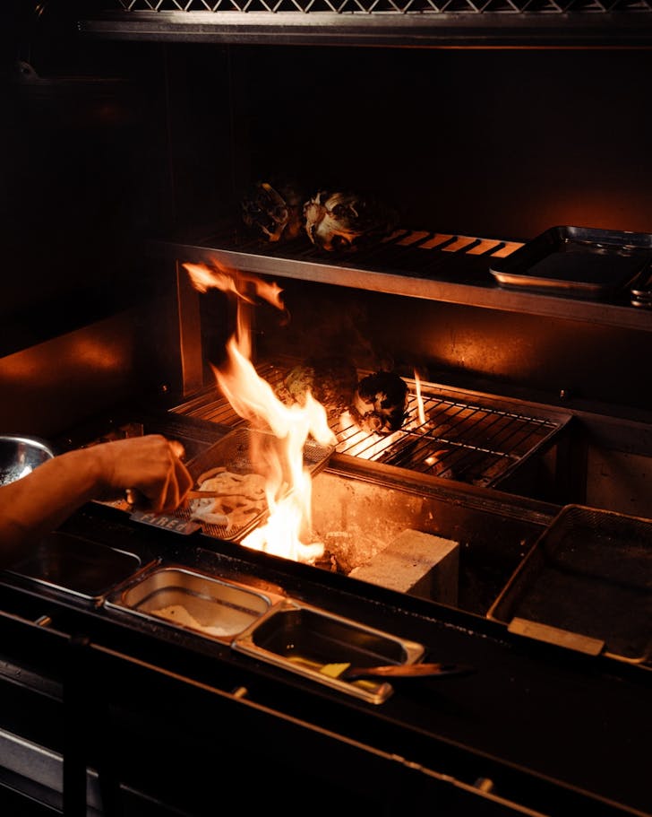 a flaming grill at japanese restaurant ibushi