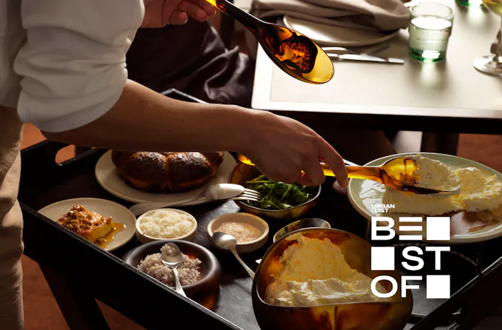 A waiter serves food from a trolley tableside at one of Sydney's best new restaurants.