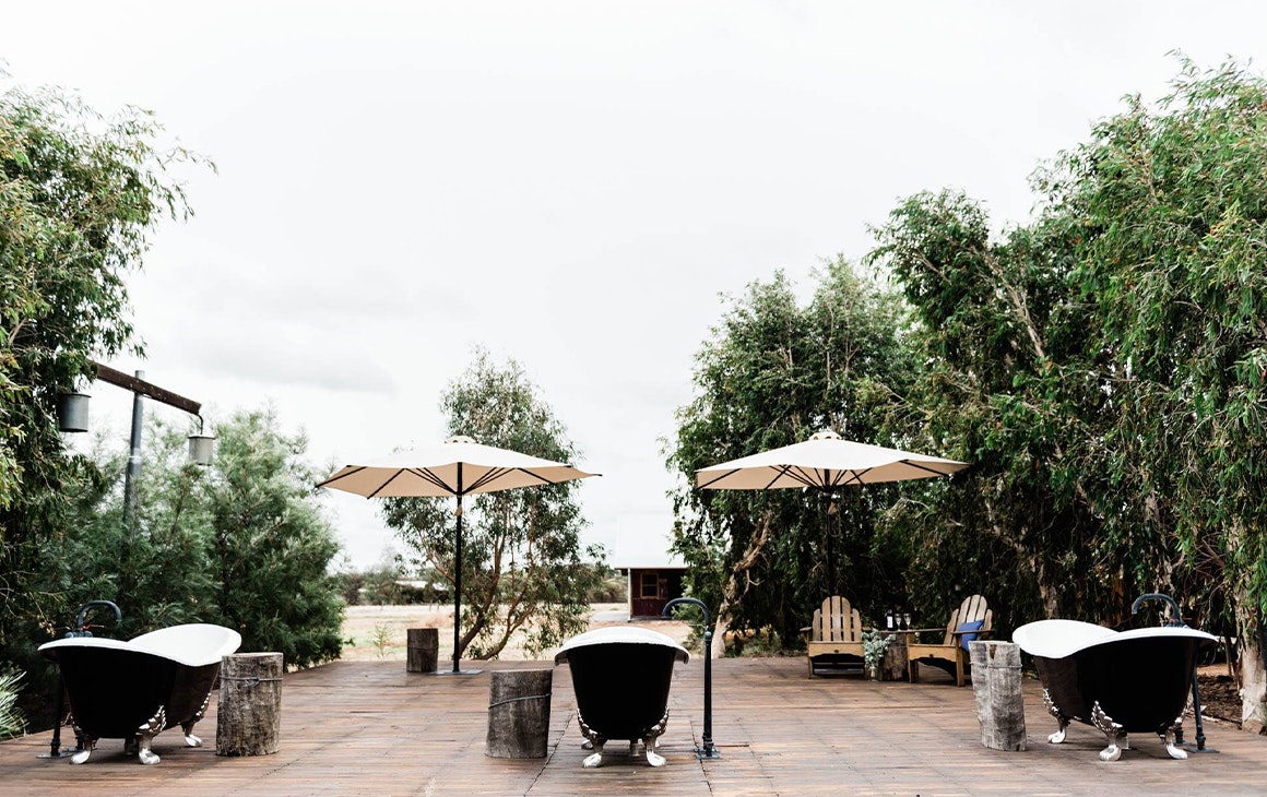 three bathtubs outdoors on an open deck