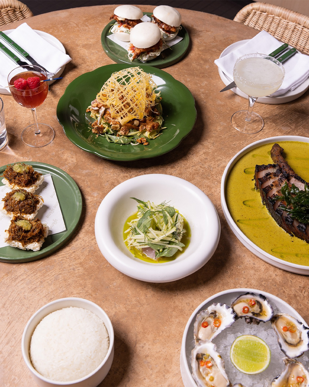 plates of thai food on a table at brisbane restaurant same same