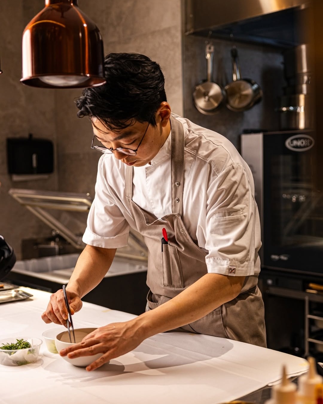 Chef Jung-Su Chang working in the kitchen at Korean restaurant Allta in the Sydney CBD