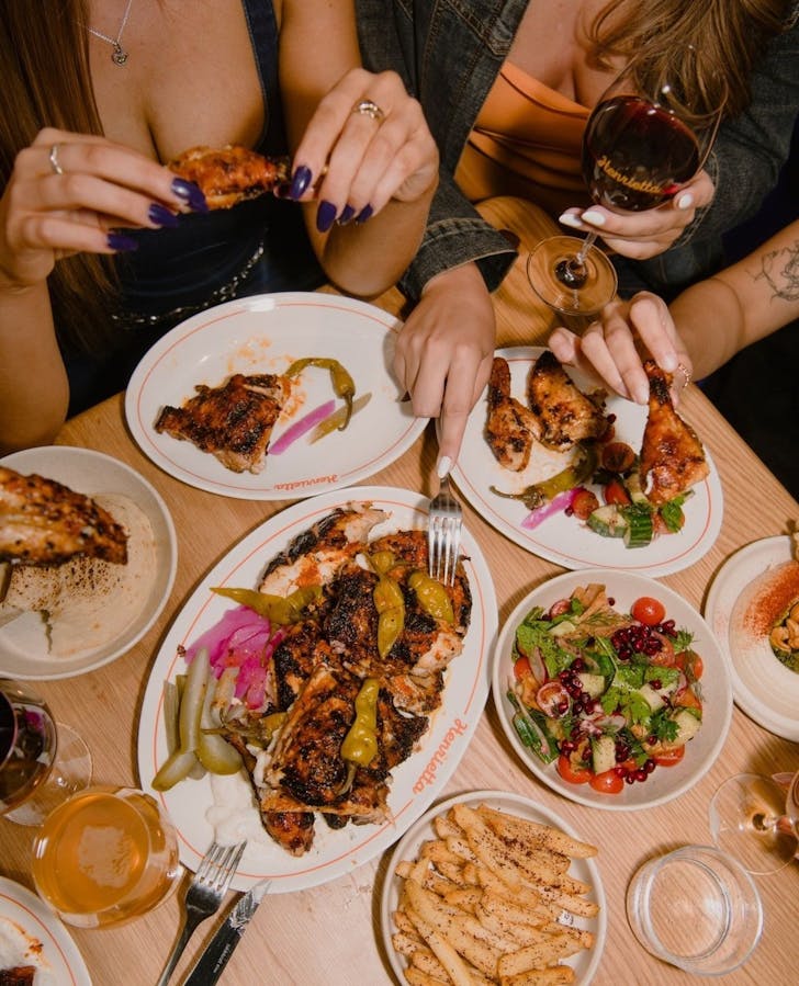 a spread of lebanese food including charcoal chicken and salads at surry hills restaurant henrietta