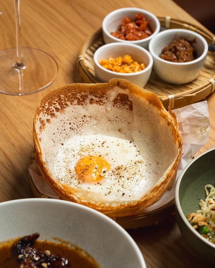 a classic egg hopper and sri lankan side dishes at surry hills restaurant kurumba