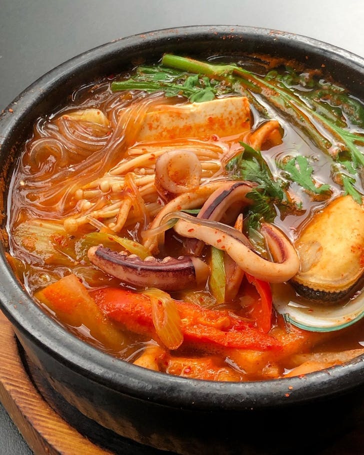 a bowl of soup with noodles and seafood at surry hills restaurant sang by mabasa