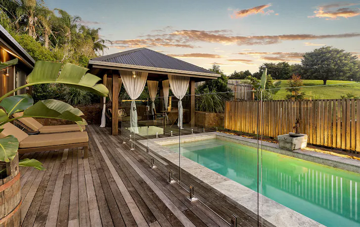 a gorgeous pool surrounded by deck chairs