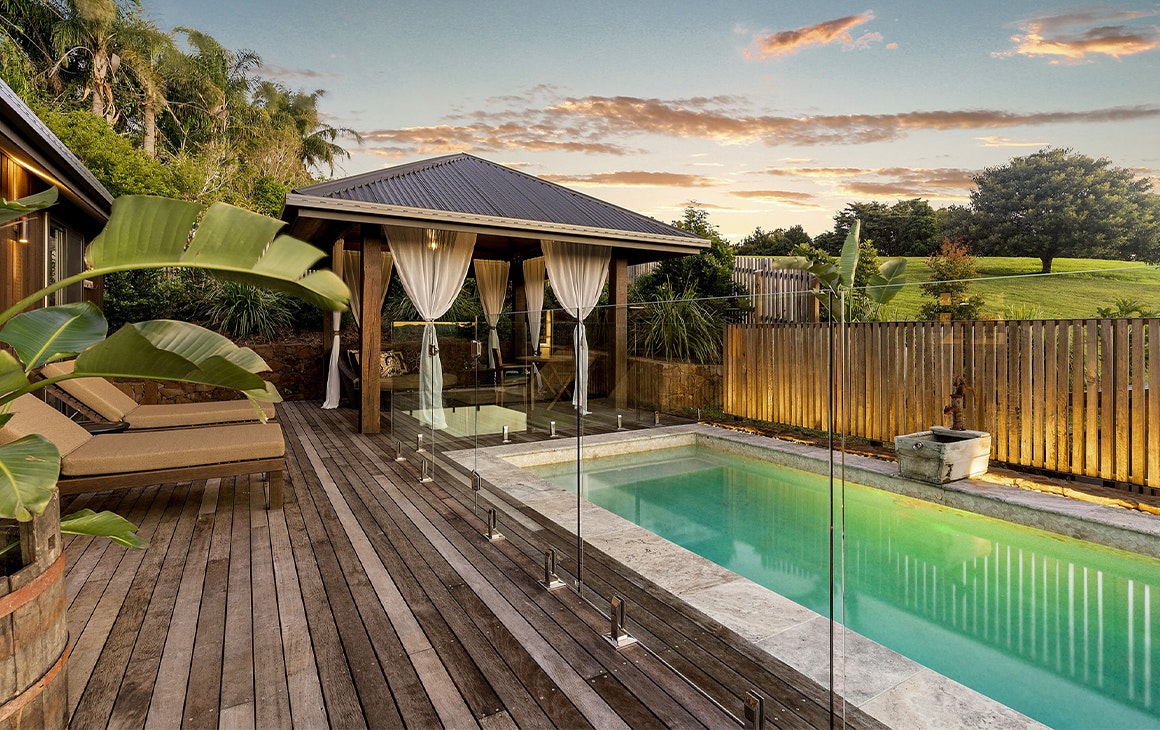 a gorgeous pool surrounded by deck chairs