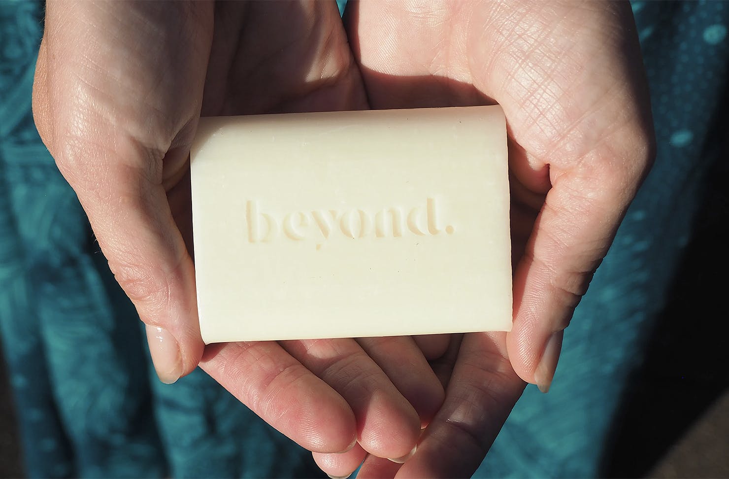 A hand cradles a bar of soap.